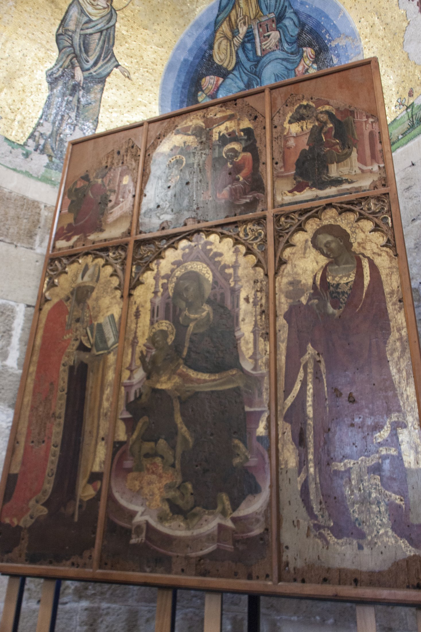 Le tavole a fondo oro del polittico: un santo vescovo con il libro, la Madonna in trono col Bambino e una santa, sotto archetti trilobati dorati